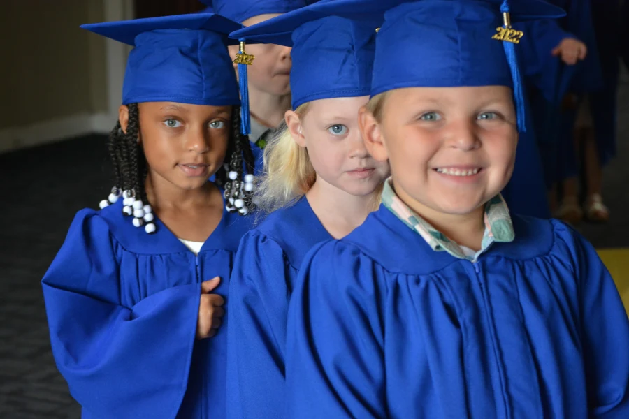 young children in graduation caps and gowns at college prep school