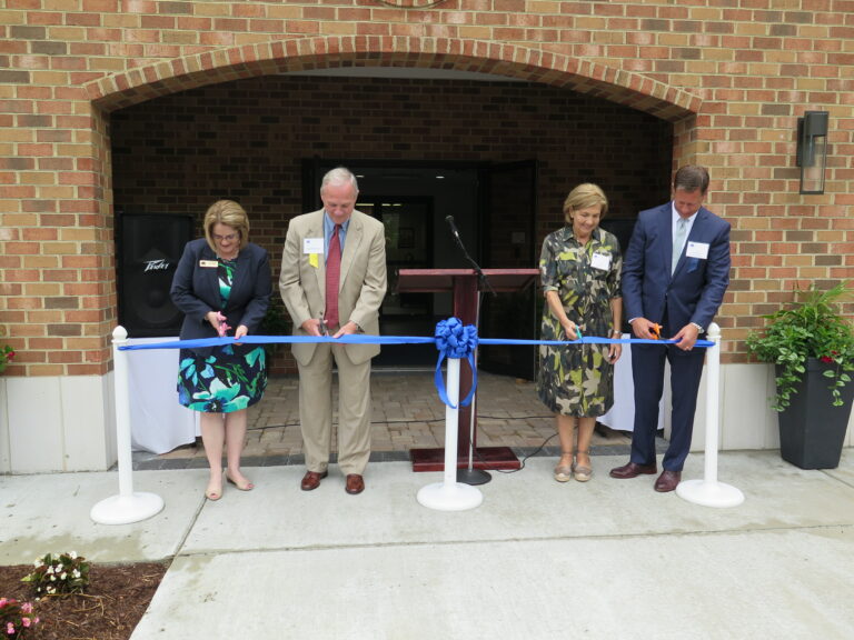 Ribbon cutting ceremony for the opening of the renovated entrance at the front of the school, during the Opening Doors campaign. From left to right: former Head of School Kathy Rader, Judge Richard S. Bray, SBS Founder Dr. Carole Adams, and Board Chair Eric Plumlee.