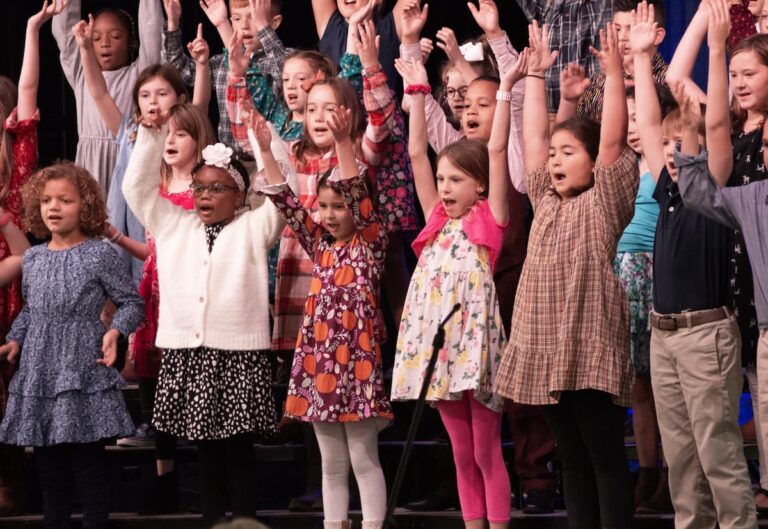 A group of StoneBridge School students singing at a school-hosted fall concert